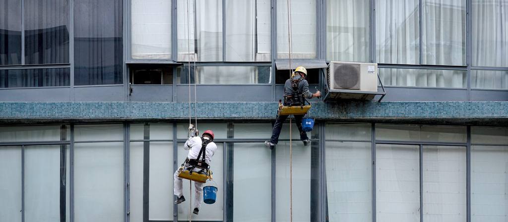 Laveurs de vitres suspendus sur une façade